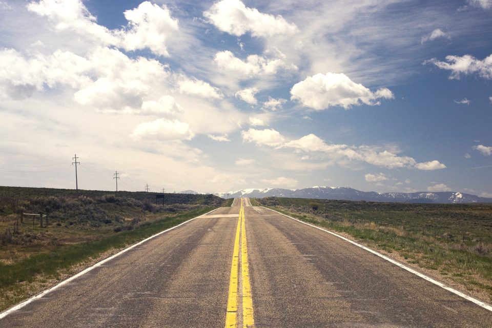 empty road with yellow median lines